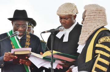 President Jonathan taking the oath of office administered by Chief Justice of Nigeria Aloysius Katsina-Alu and the Registrar, Mr Sunday Olorundahunsi ... yesterday